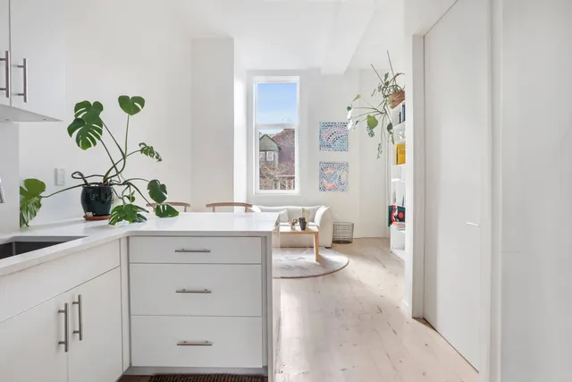 a spacious en suite bathroom with a granite countertop sink and a mirror