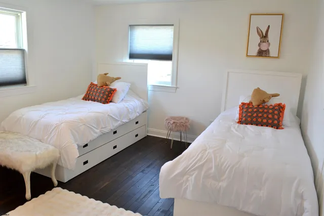 a bedroom with bed and wooden floor