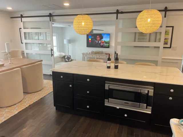 a kitchen with a sink appliances and a mirror