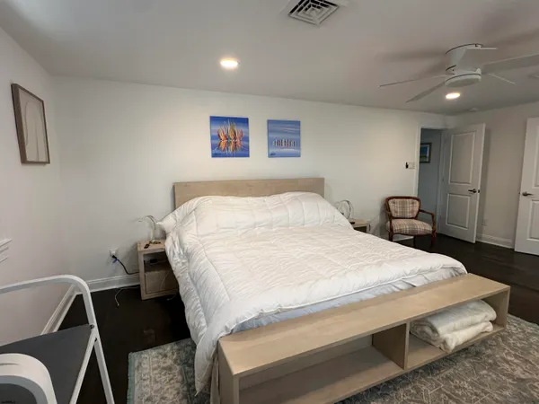 a bedroom with a bed and a chair