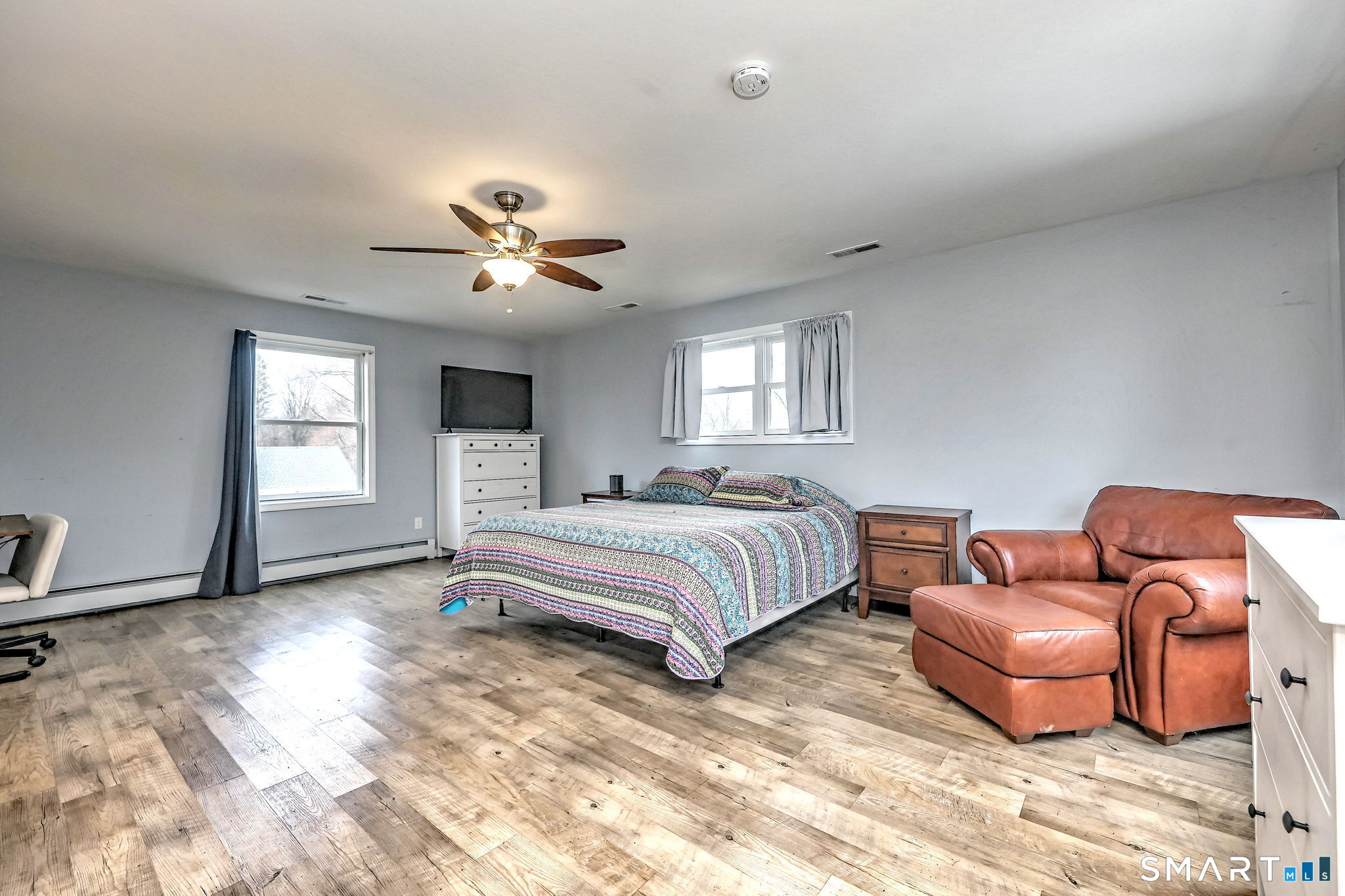 4 Fairview Road Woodbridge, CT 06525 - Photo 22 of 37 The private primary bedroom suite located above the garage, featuring a spacious layout, modern full bath, walk in closet and plentiful windows creating a bright airy retreat.