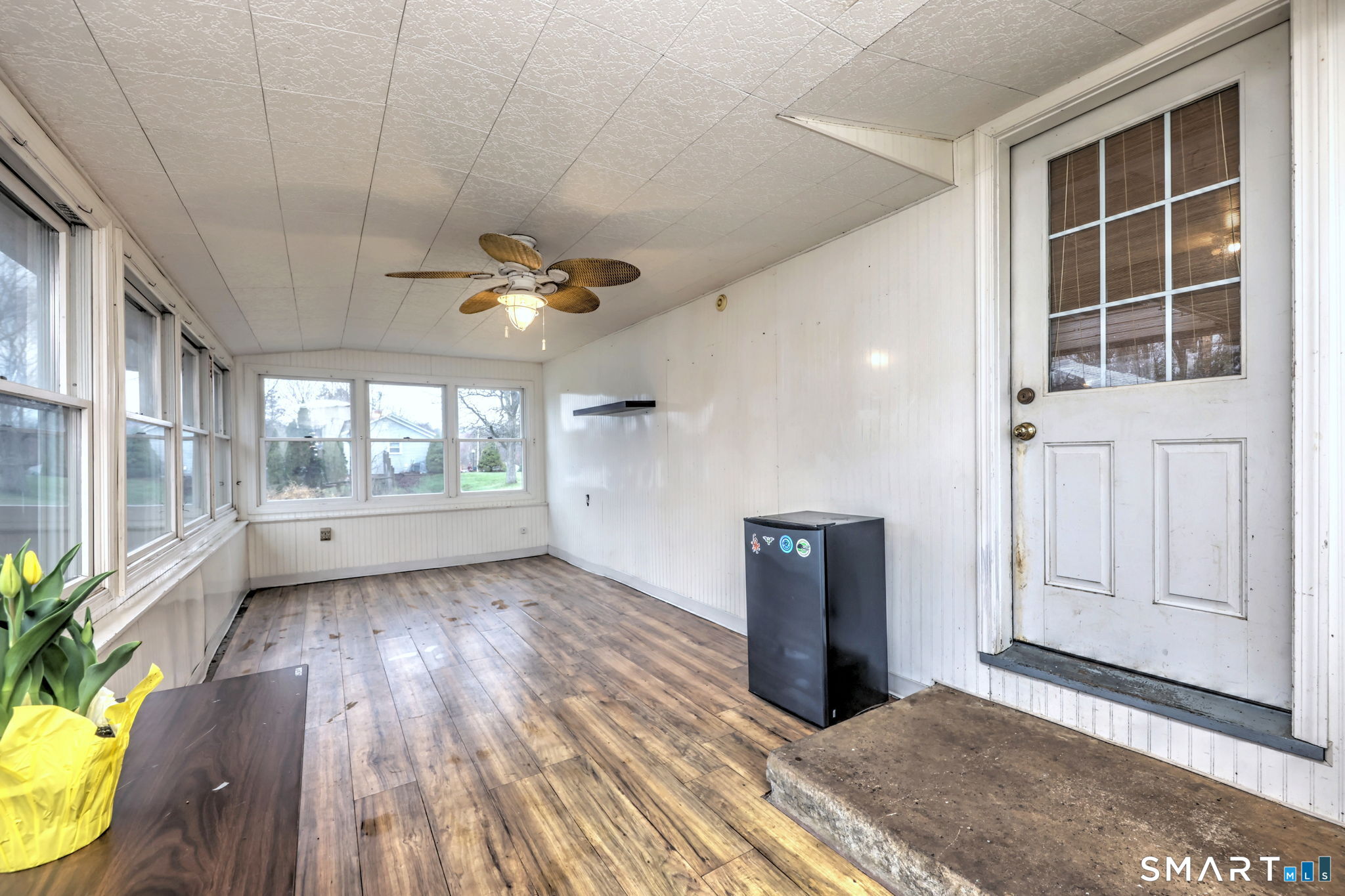 4 Fairview Road Woodbridge, CT 06525 - Photo 27 of 37 A delightful surprise, the sun porch is tucked off the back of the home, surrounded by windows with lovely views of the yard and offering a private peaceful retreat.