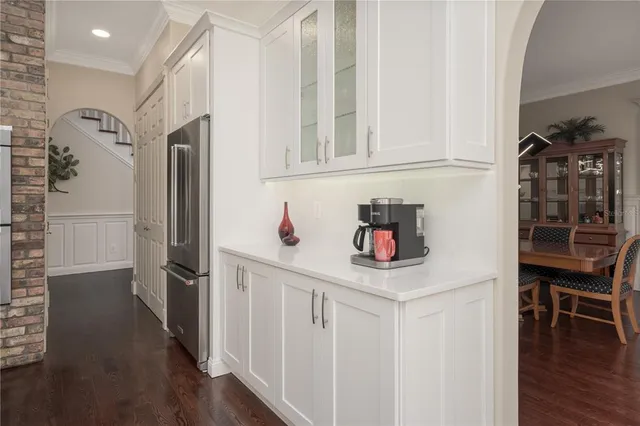 a bathroom with a granite countertop double vanity sink and mirror