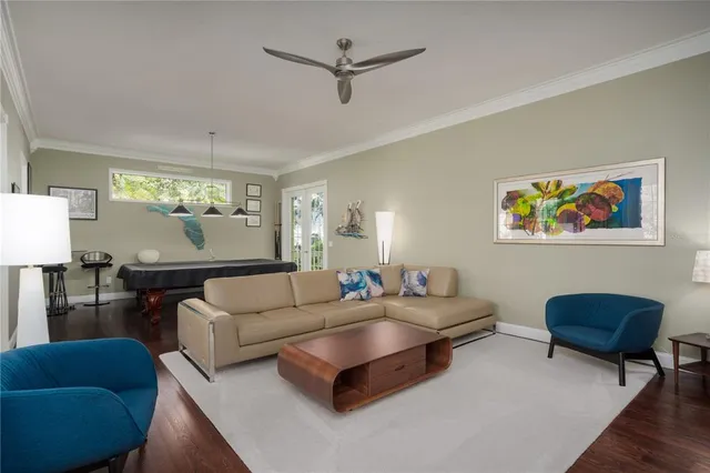 a living room with furniture and a chandelier