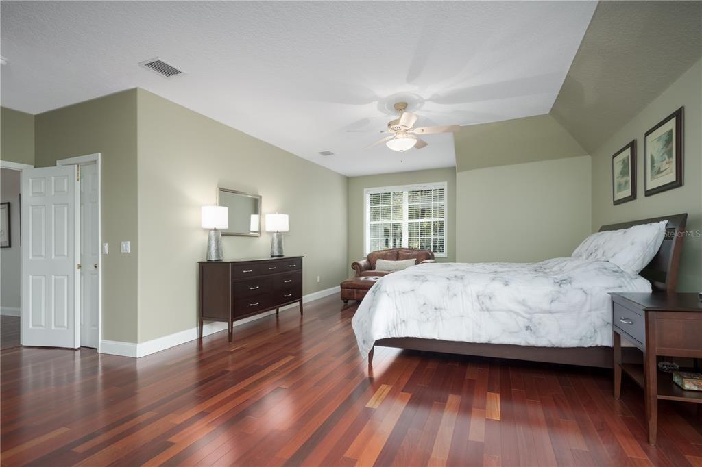 7 Bulow's Landing Flagler Beach, FL 32136 - Photo 50 of 92 a spacious bedroom with a bed and wooden floor