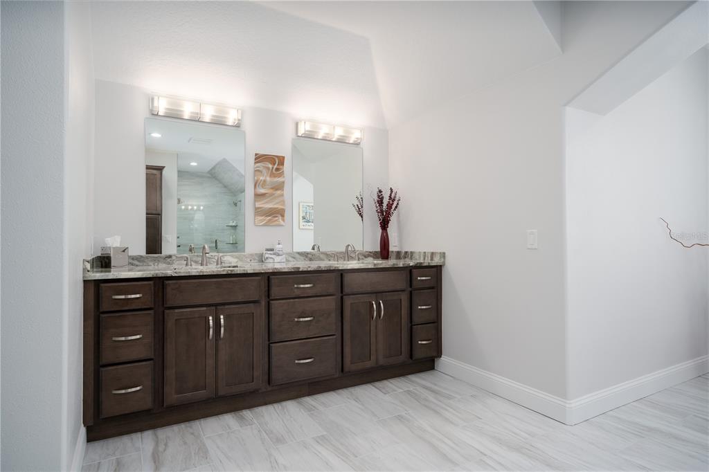 7 Bulow's Landing Flagler Beach, FL 32136 - Photo 54 of 92 a bathroom with a granite countertop double vanity sink and mirror