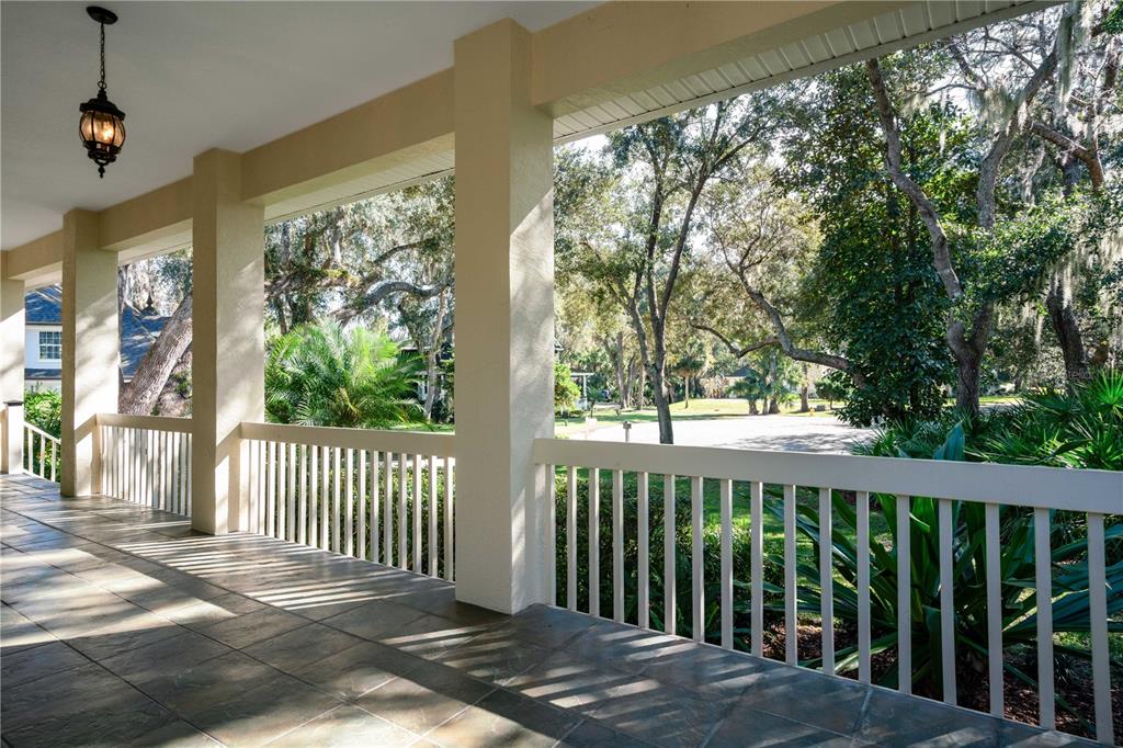 7 Bulow's Landing Flagler Beach, FL 32136 - Photo 10 of 92 a view of a porch with a floor to ceiling window and wooden fence