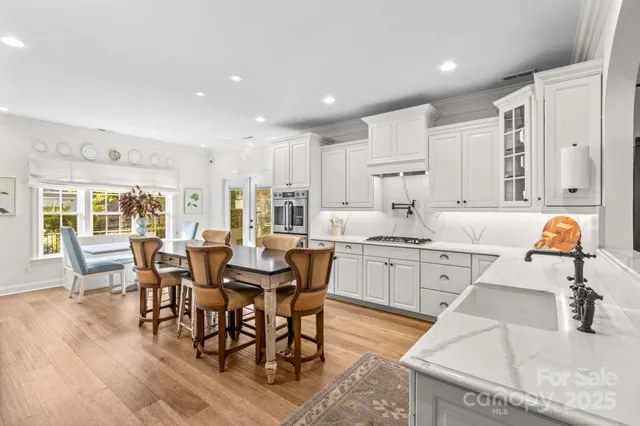 a kitchen with kitchen island a appliances dining table and chairs