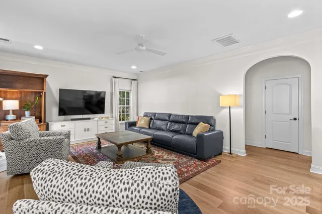 a living room with furniture a large window and a fireplace