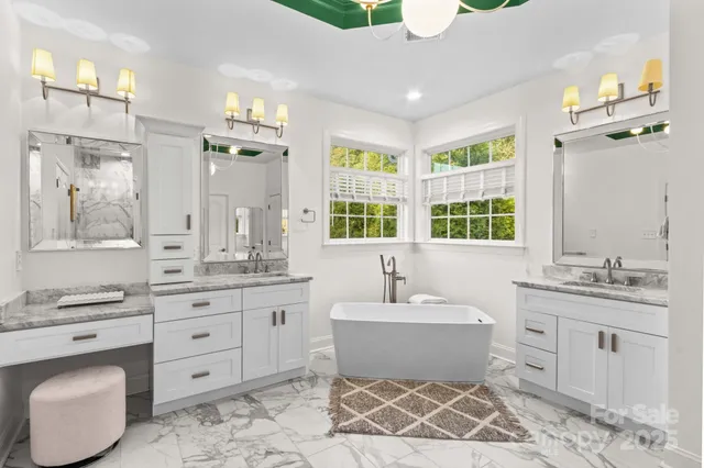 a bathroom with a sink mirror and shower