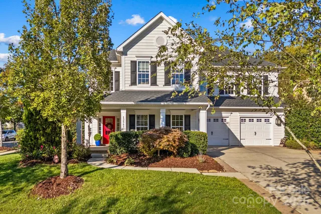 a front view of a house with a yard and porch