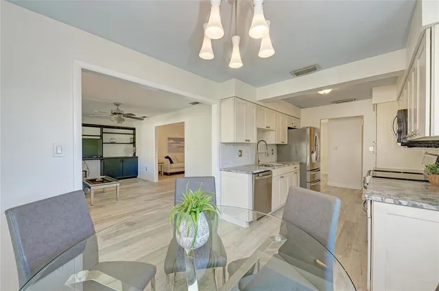 a kitchen with refrigerator and cabinets
