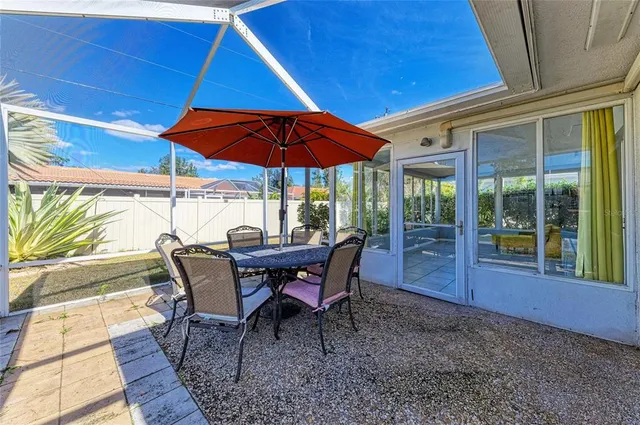 a view of a backyard with a deck and furniture