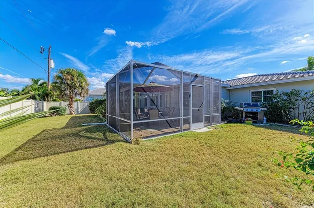 a view of a house with a backyard and a patio