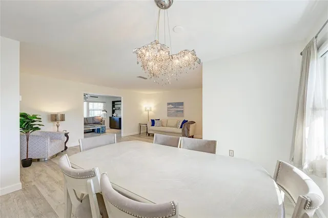 a bed room with a bed and a chandelier