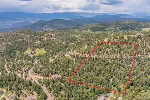 a view of a mountain range with lush green hillside