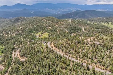 a view of a mountain range in a cloudy sky
