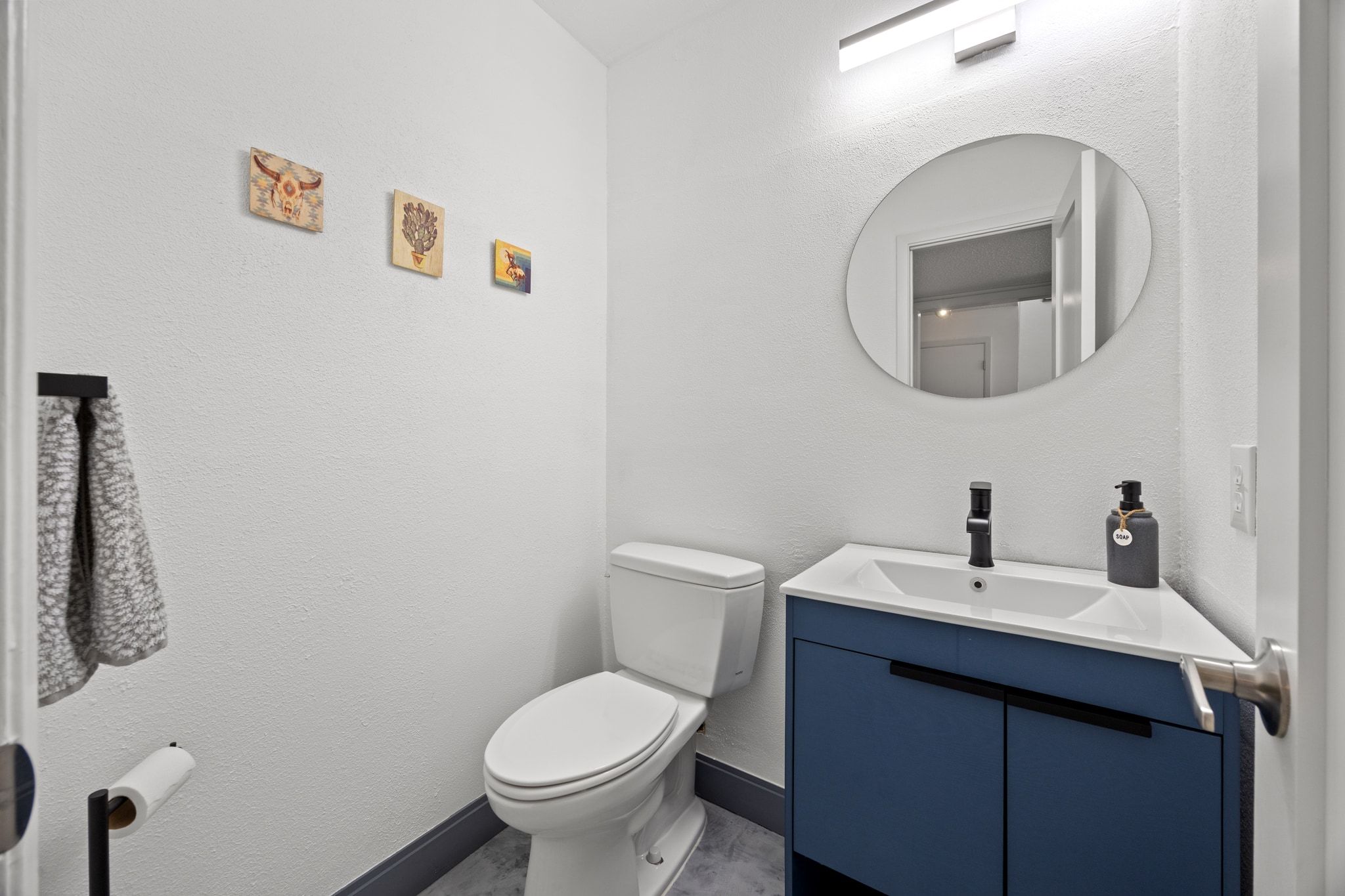 7256 Coronado Circle Austin, TX 78752 - Photo 16 of 26 Bathroom featuring vanity and a textured wall