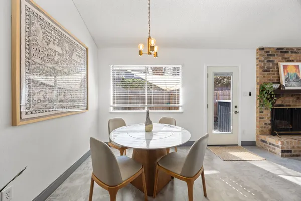 a dining room with furniture and window