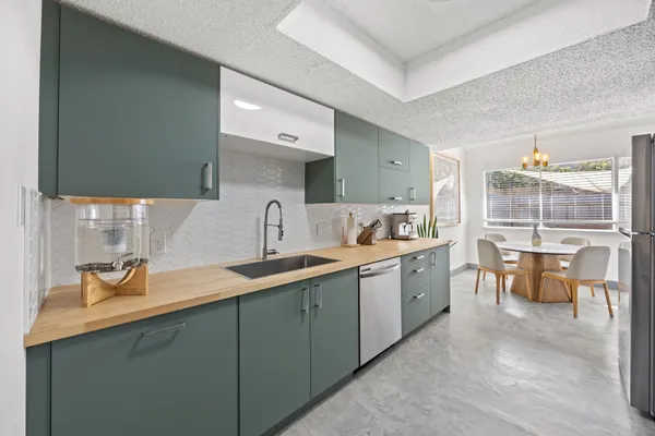 a kitchen with sink and cabinets