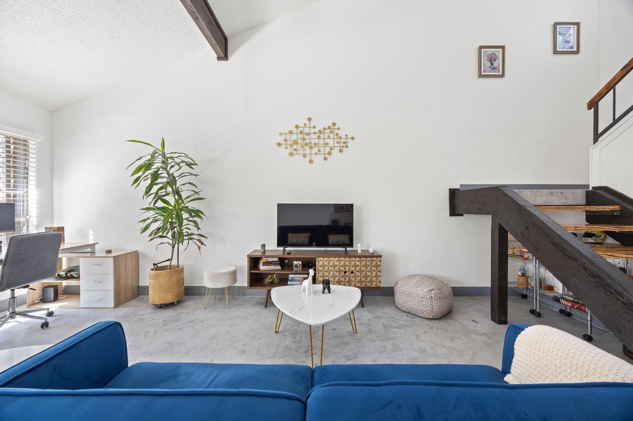 7256 Coronado Circle Austin, TX 78752 - Photo 10 of 26 Carpeted living room with a desk and vaulted ceiling