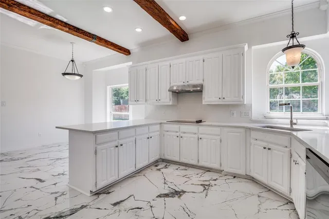 a kitchen with sink cabinets and window