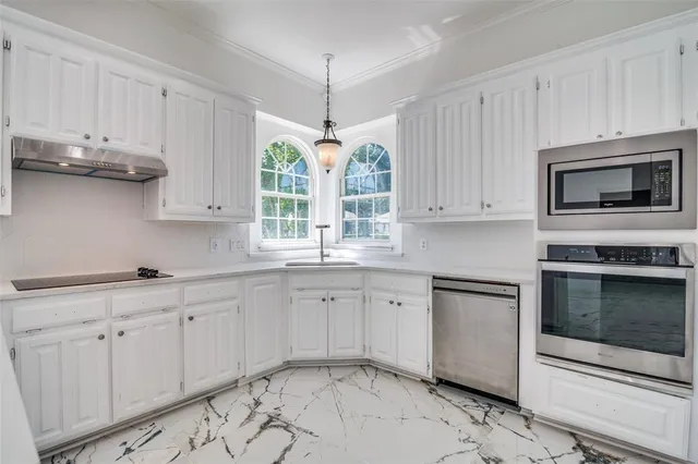 a kitchen with appliances cabinets and a sink