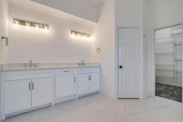a spacious bathroom with a granite countertop sink and mirror