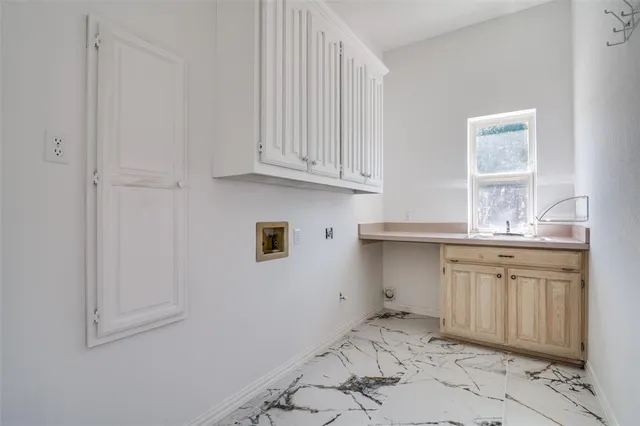 a kitchen with granite countertop white cabinets and sink