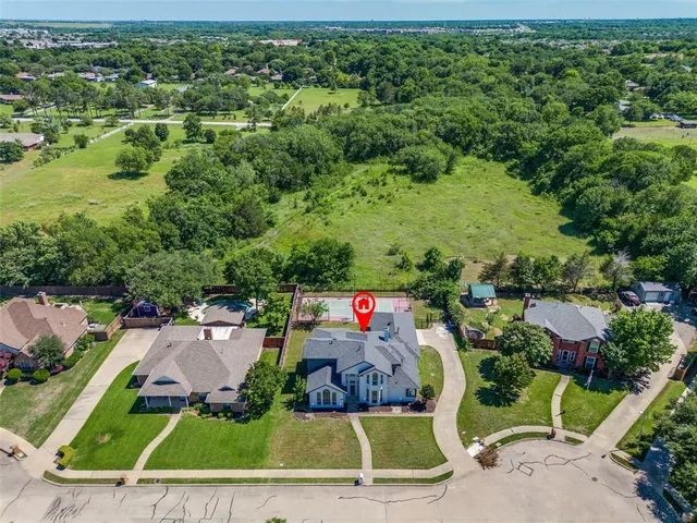 an aerial view of a house with a yard
