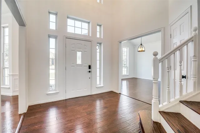 a view of an entryway with wooden floor and stairs