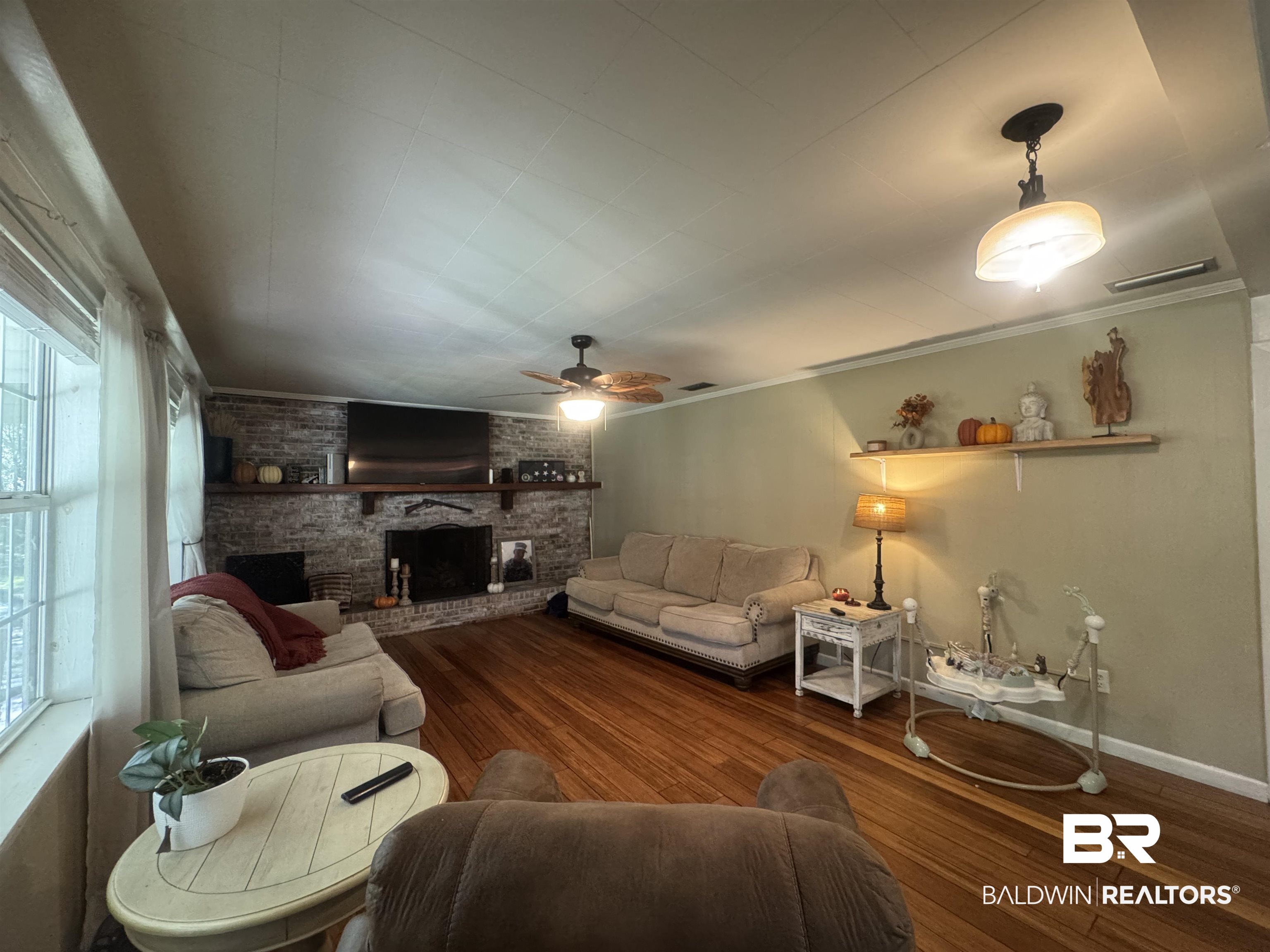 3097 Old Castleberry Road Brewton, AL 36426 - Photo 3 of 49 Living room featuring ornamental molding, wood-type flooring, a fireplace, and ceiling fan