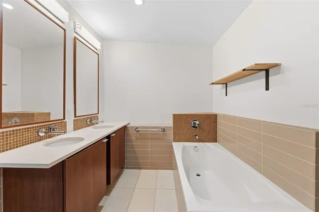 a bathroom with a sink a mirror and a bathtub