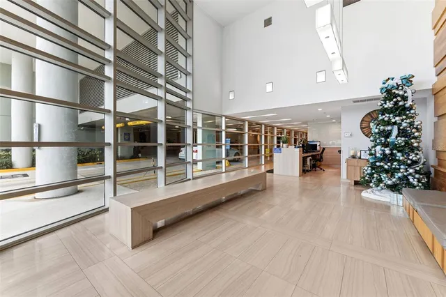 a lobby with furniture and a potted plant