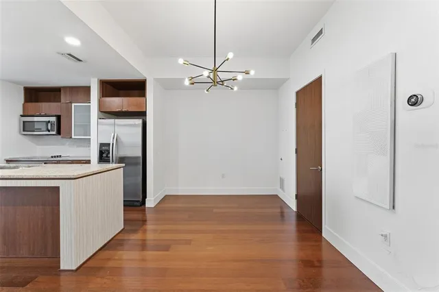 a view of a kitchen with a sink cabinets and wooden floor
