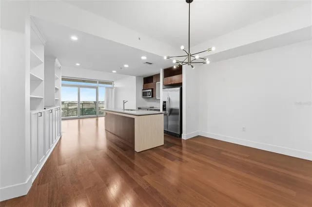 a view of a kitchen with a sink and wooden floor