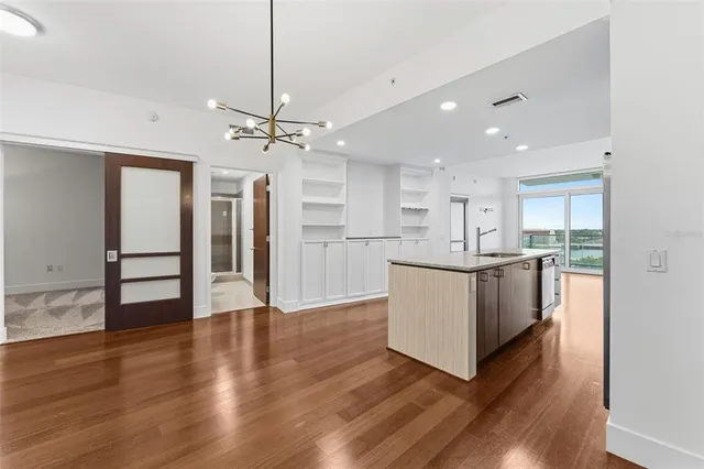 a view of a kitchen with wooden floor and a counter top space
