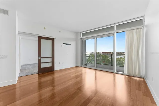 wooden floor in an empty room with a window