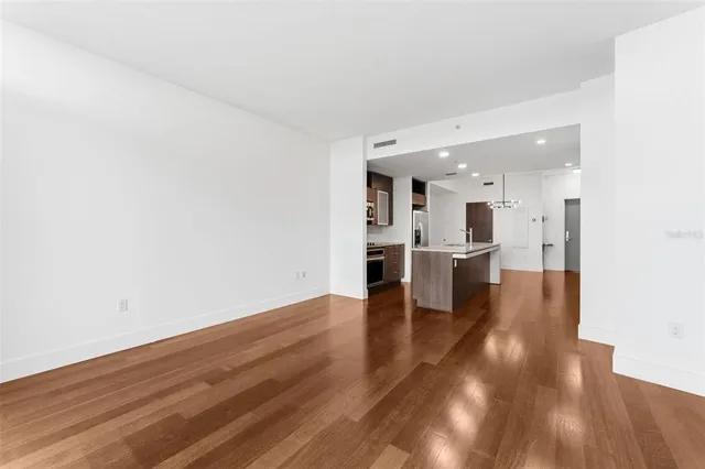 a view of a kitchen with wooden floor and a sink