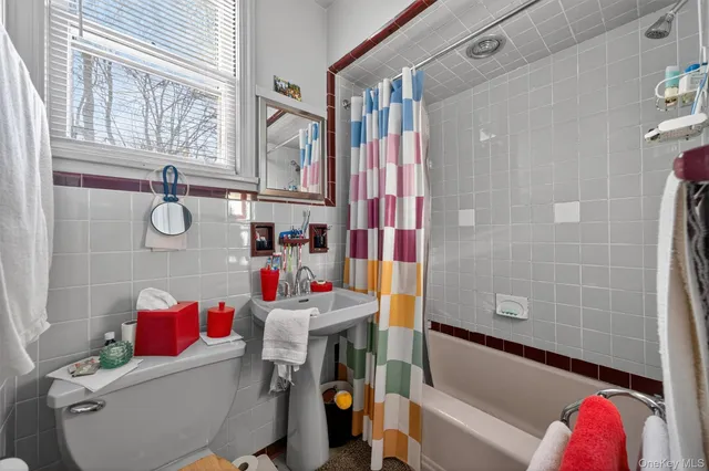 a living room with furniture fireplace and a large window