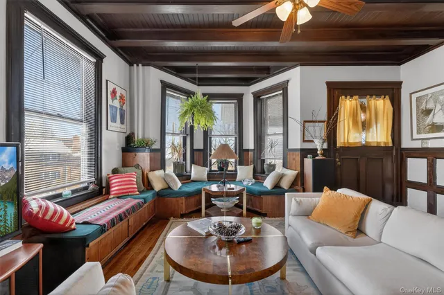 a living room with furniture and a potted plant