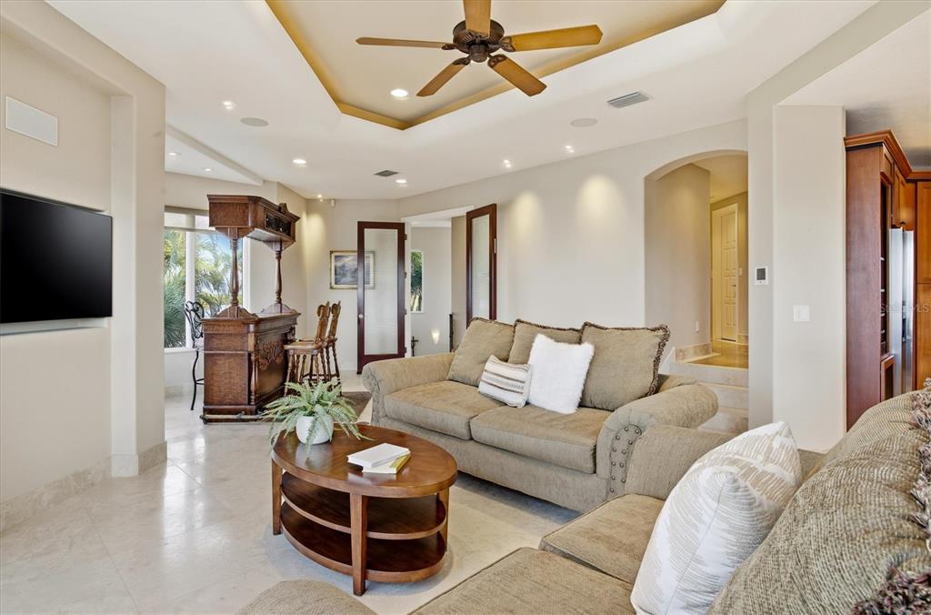 761 Norton Street Longboat Key, FL 34228 - Photo 35 of 66 a living room with furniture a flat screen tv and a chandelier