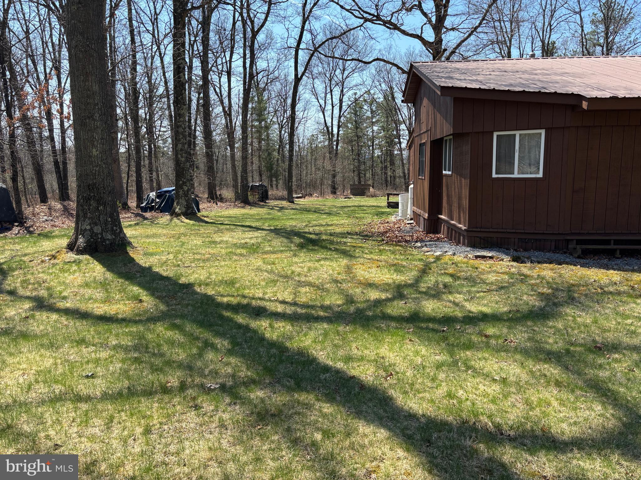 1066 Eddy Ridge Road Orviston, PA 16864 - Photo 11 of 44 a backyard of a house with lots of green space
