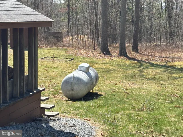 a view of a backyard with table and chairs and wooden fence