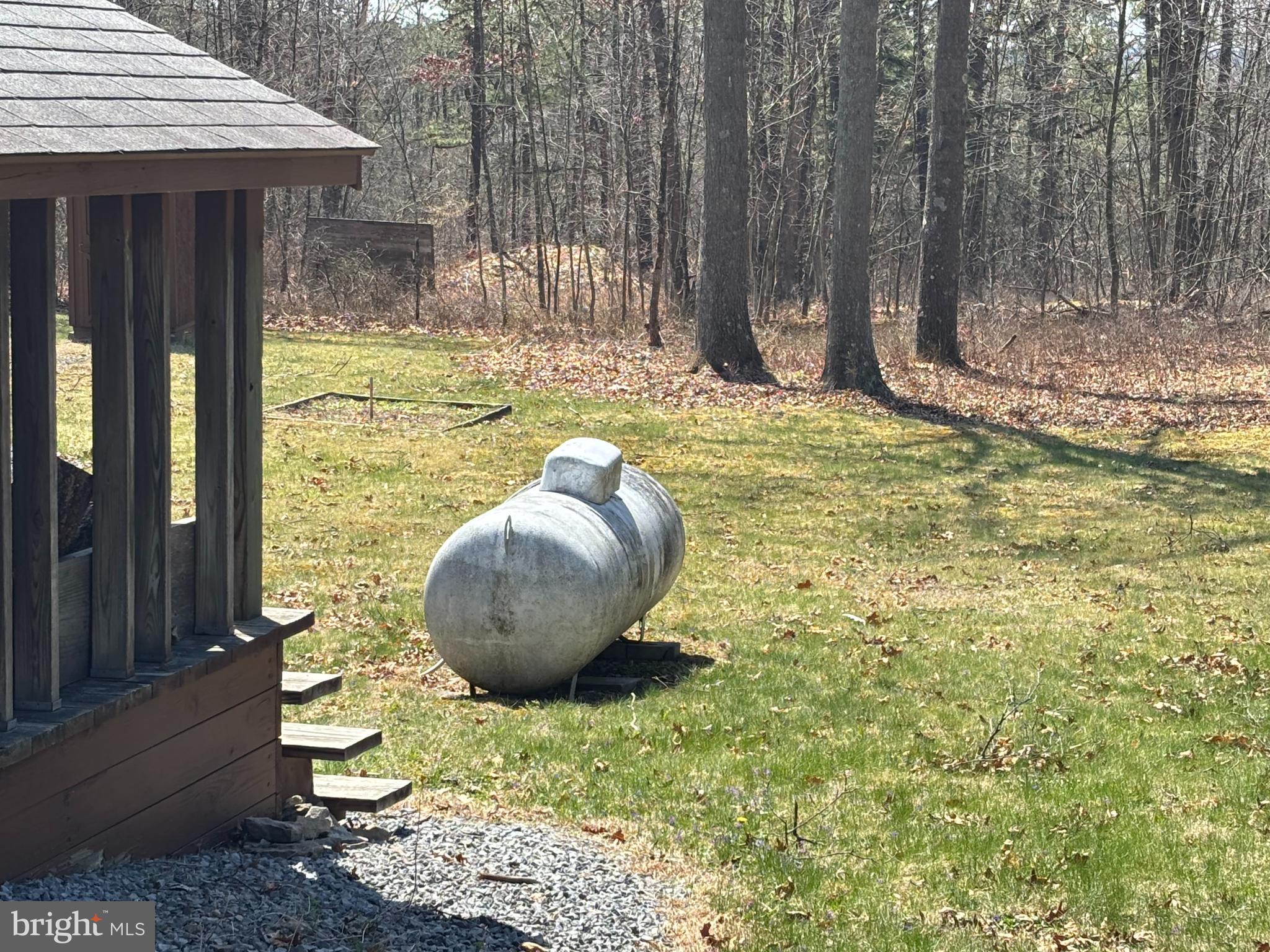 1066 Eddy Ridge Road Orviston, PA 16864 - Photo 16 of 44 a view of a backyard with table and chairs and wooden fence