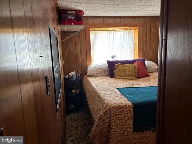 a bedroom with a bed closet and a window