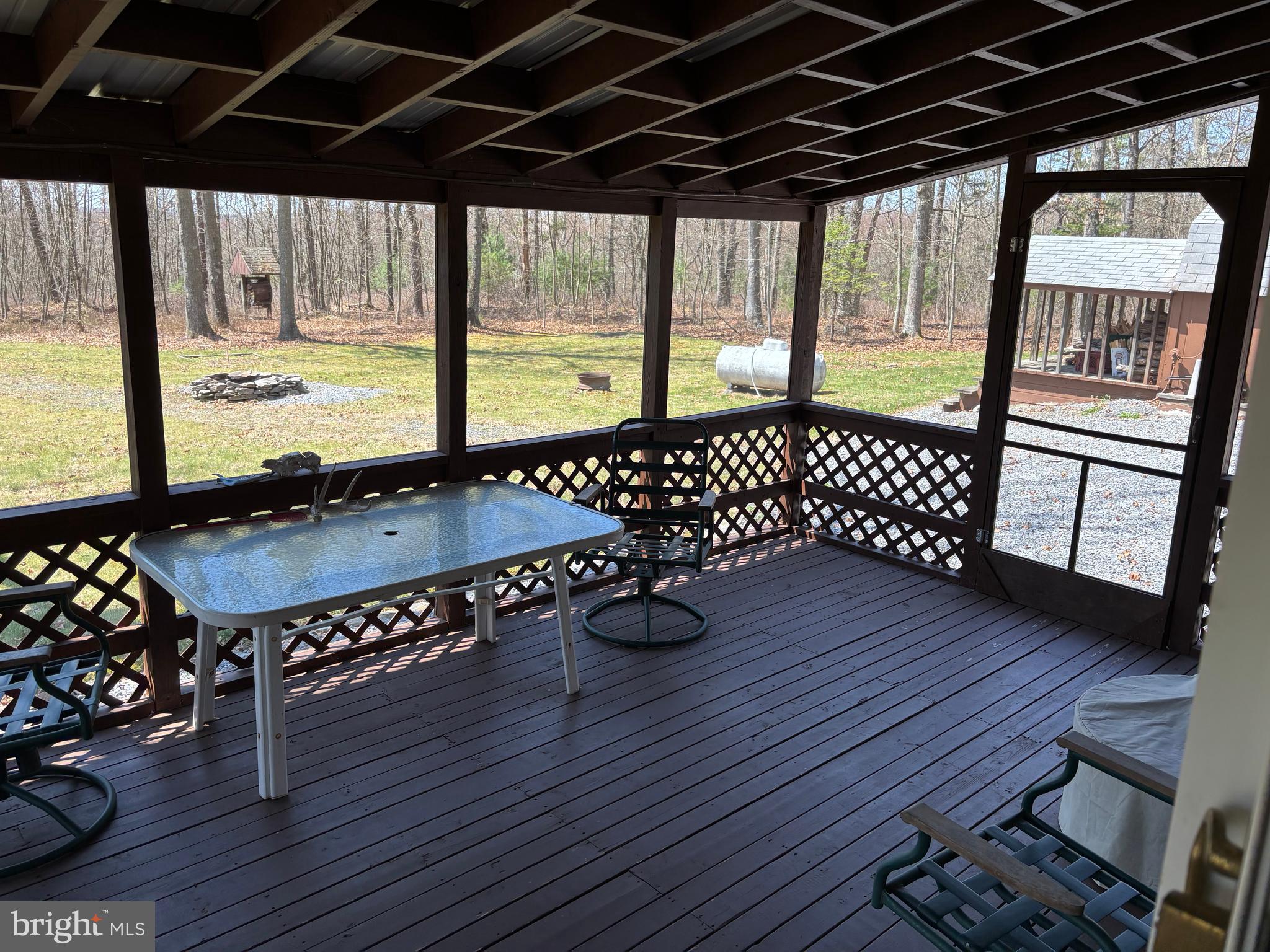 1066 Eddy Ridge Road Orviston, PA 16864 - Photo 38 of 44 a view of a deck with wooden floor and outdoor seating
