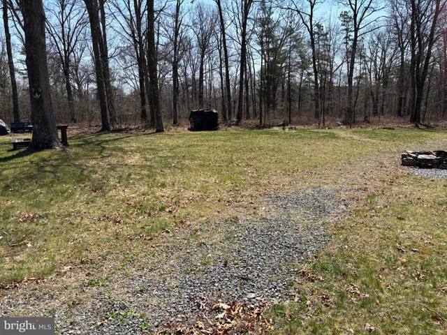 a swimming pool with outdoor seating and yard