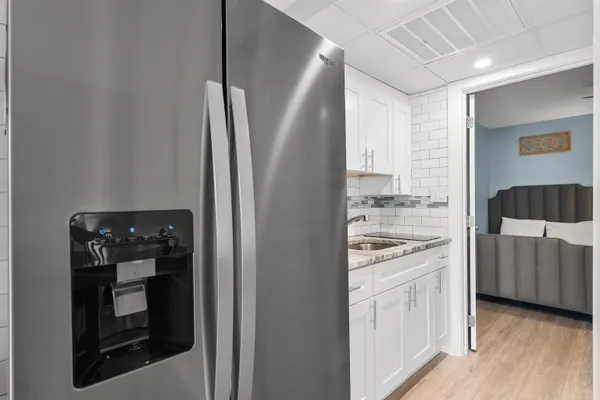 a kitchen with stainless steel appliances a refrigerator and a stove top oven