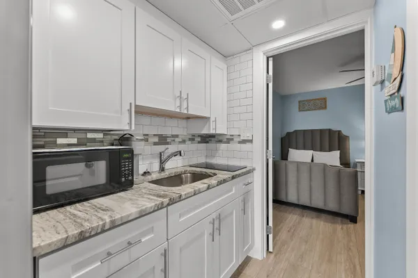 a kitchen with a sink and a stove top oven